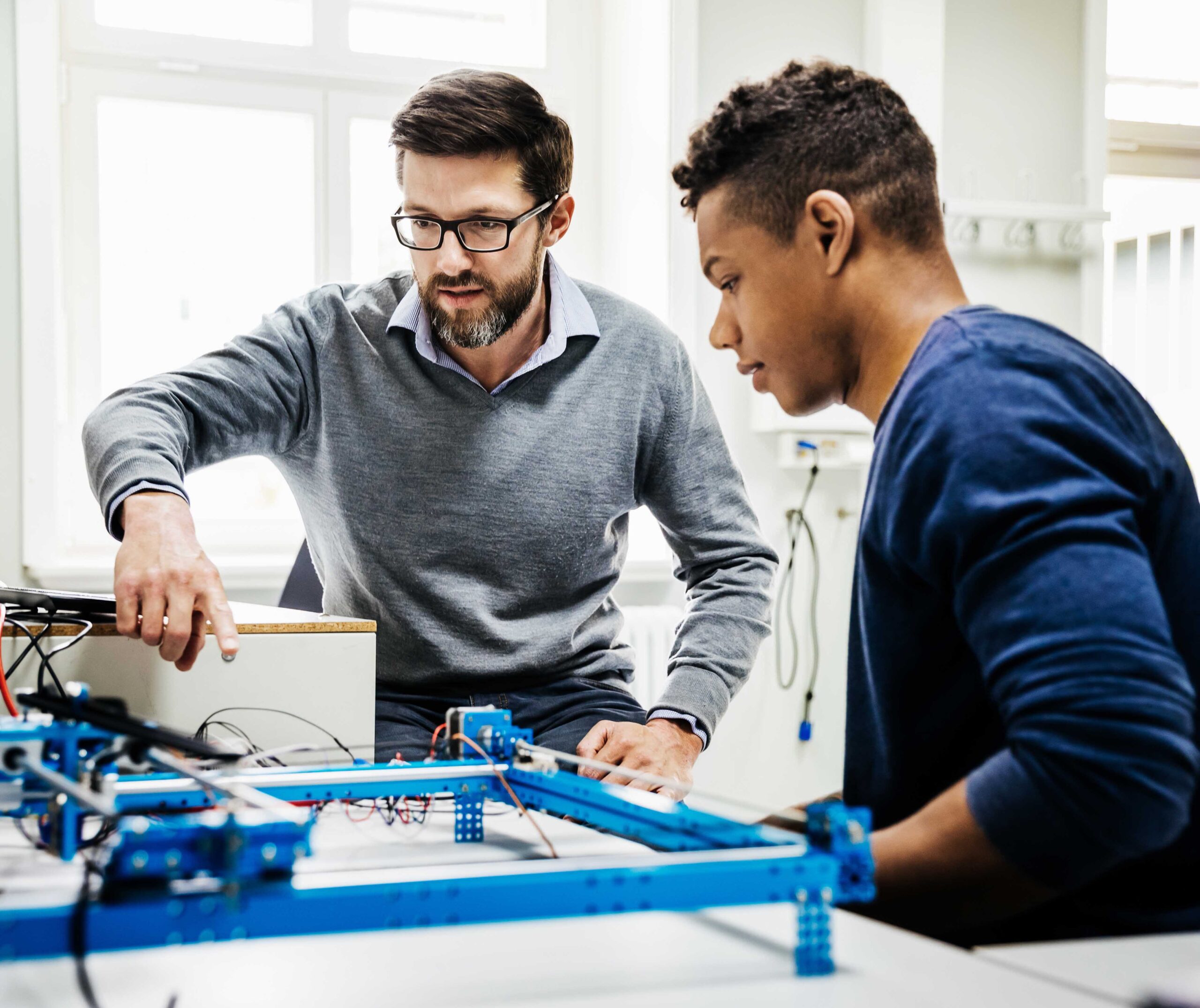 University Tutor Assisting Student With Technical Problem